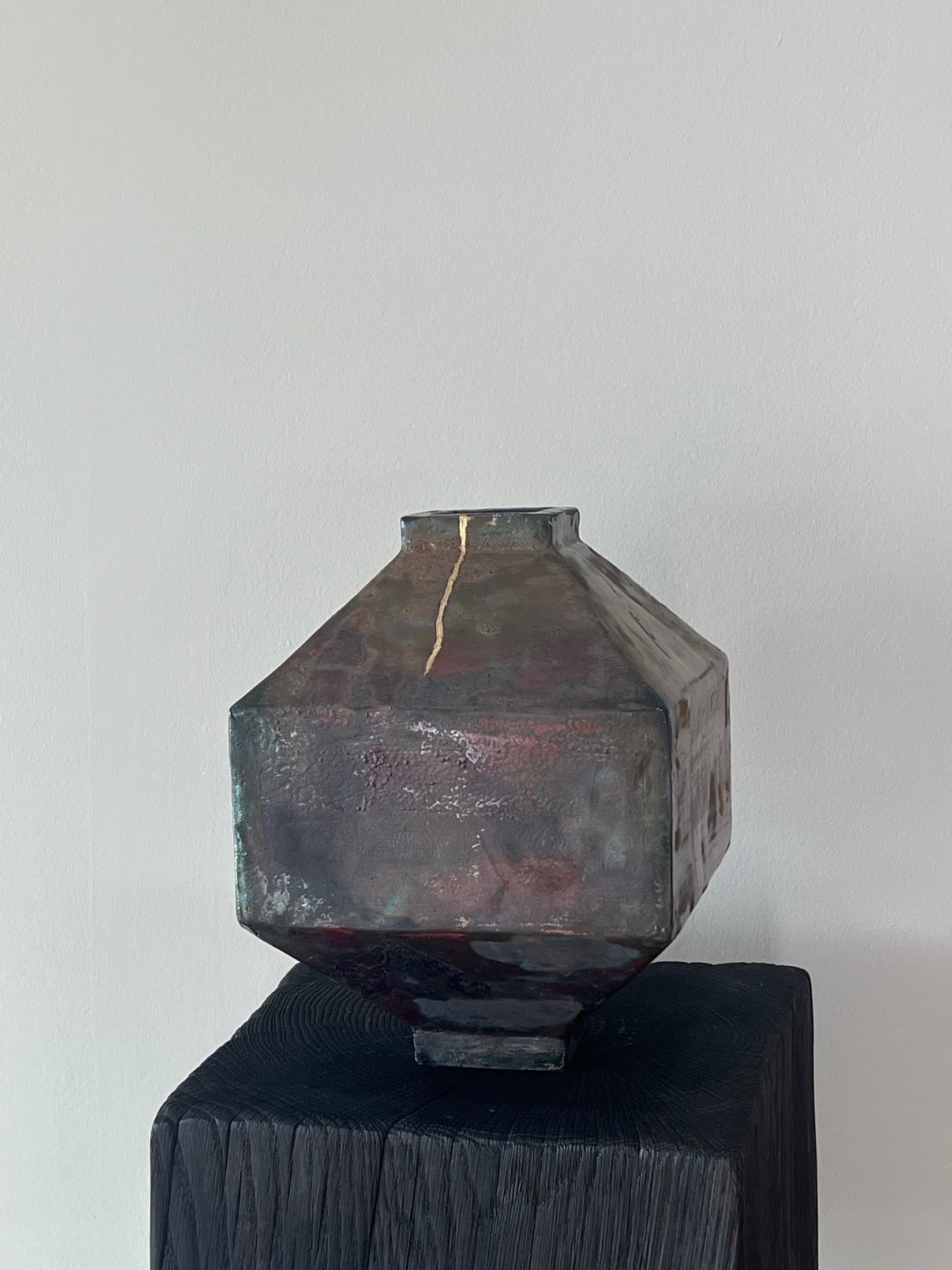 Angular vase with an iridescent glaze and a gold-repaired crack