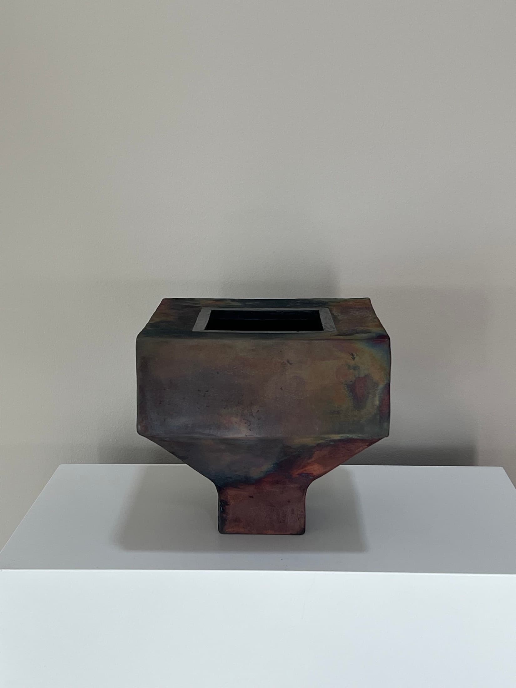 Angular vase with an iridescent copper-bronze raku glaze