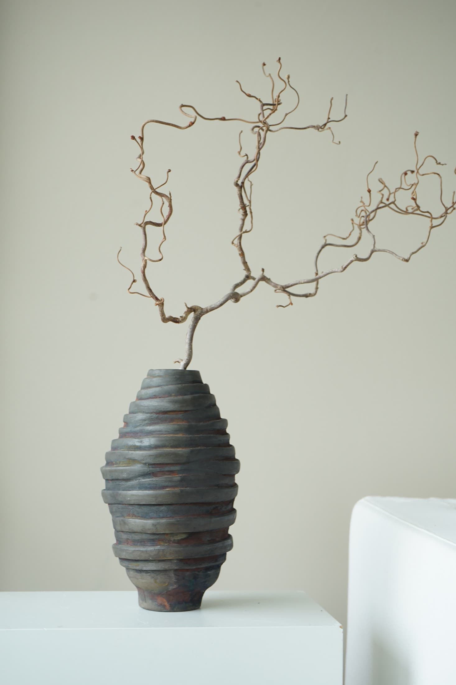 Vase with a ridged coiled texture in dark brown and grey