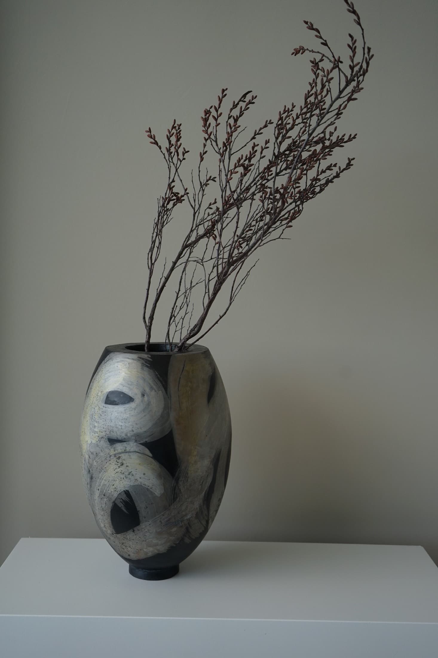 Vase with a painted sweeping pattern in black and white