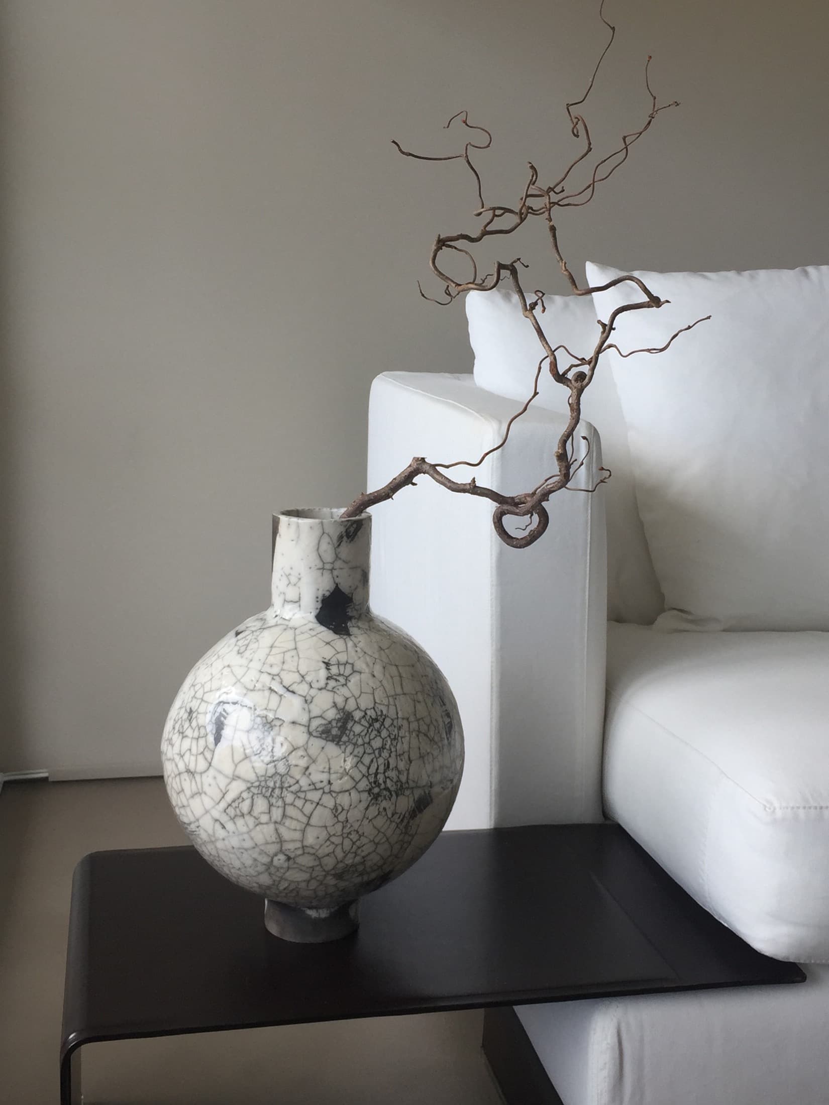 Round vase with a white crackle glaze and black patches