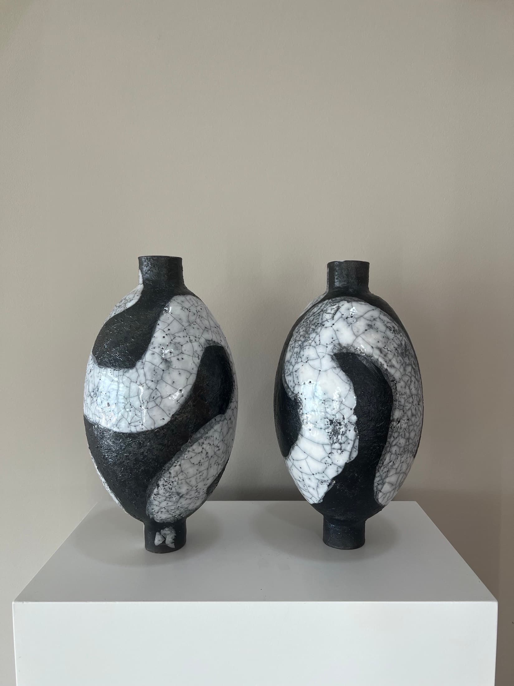 Two oval vases with a black-and-white crackle sweep pattern