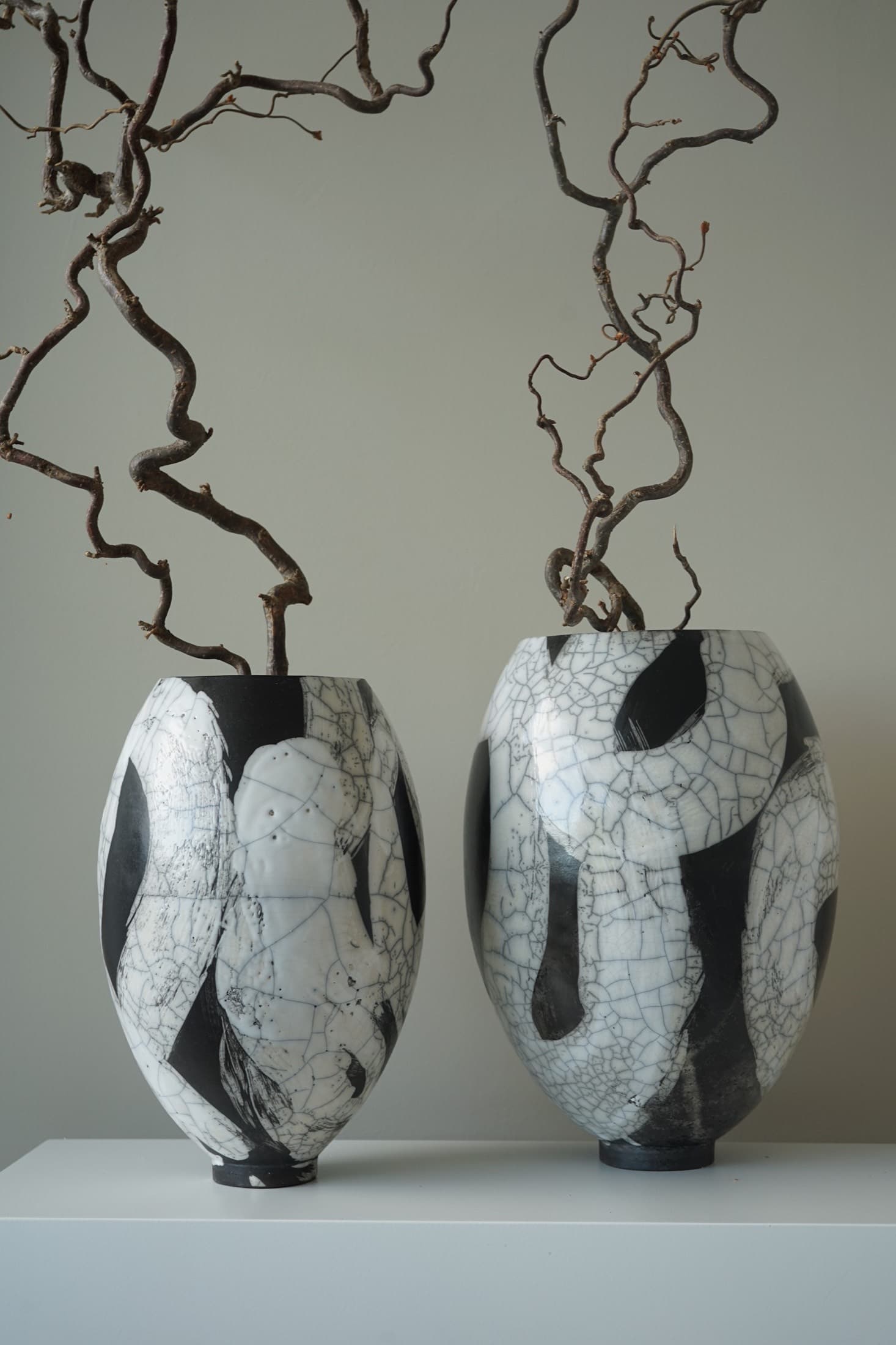 Two oval vases with a crackle glaze and brushstroke in black and white